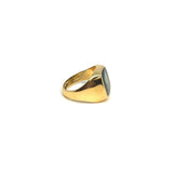 Gold hoop earring with green stone
